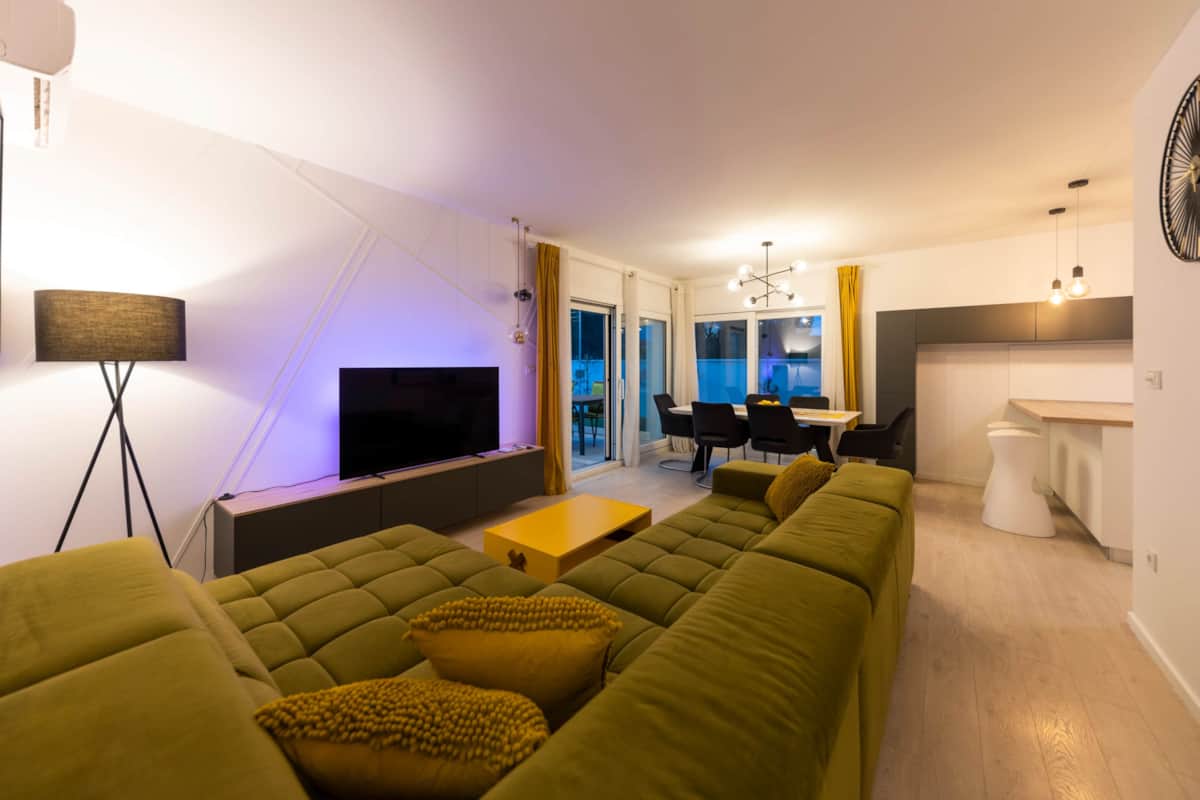 Living room with green sofa in the evening