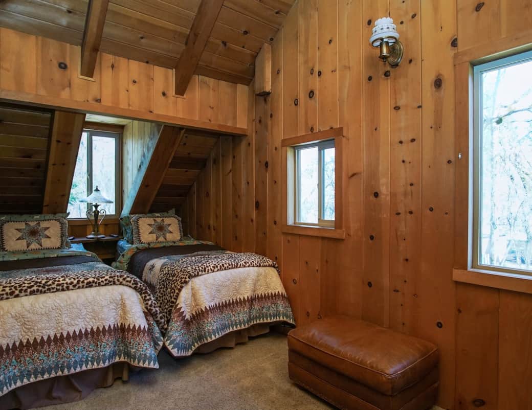 Welcome to The Twin Star Open-Concept Loft! Under vaulted pine ceilings, this cozy space features two beds in rustic chic quilts. It shares the floor with The Bridle Room, game nook, & a bathroom with a shower. Enjoy Tempur-Pedic massage beds!