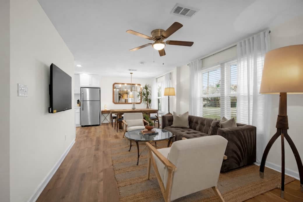 Relax in this bright, inviting living room with comfortable seating, warm décor, and a smart TV for streaming your favorite shows. Large windows fill the space with natural light, creating the perfect spot to unwind after a day exploring Houston