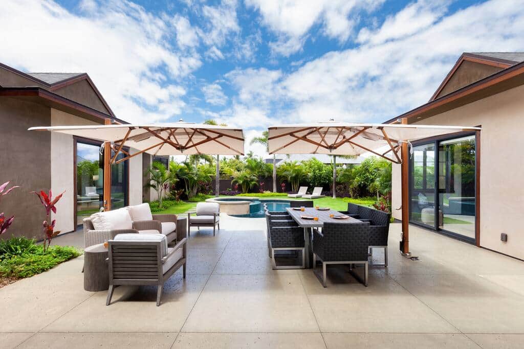 outdoor dining and comfortable lounge seating adorn the pool and lush green space