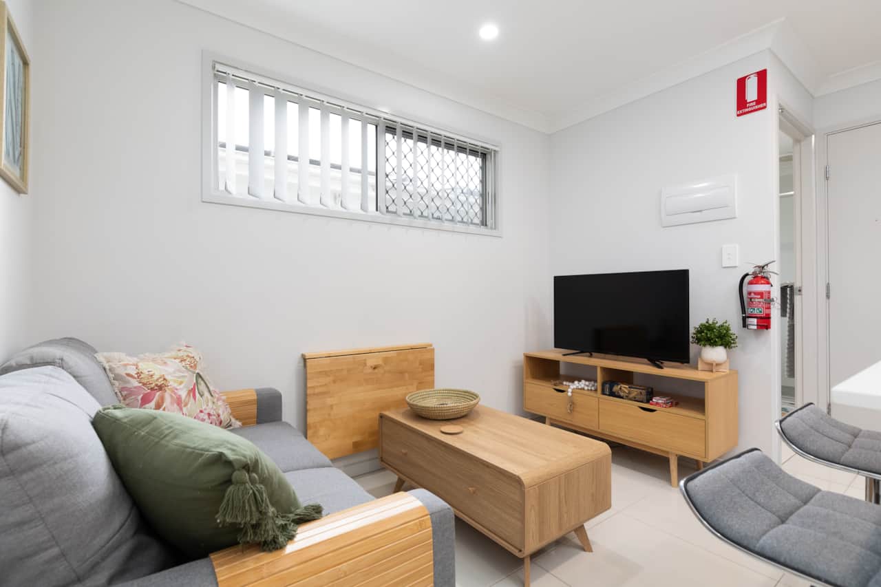 Living Area: Bright living space with comfortable seating and TV 