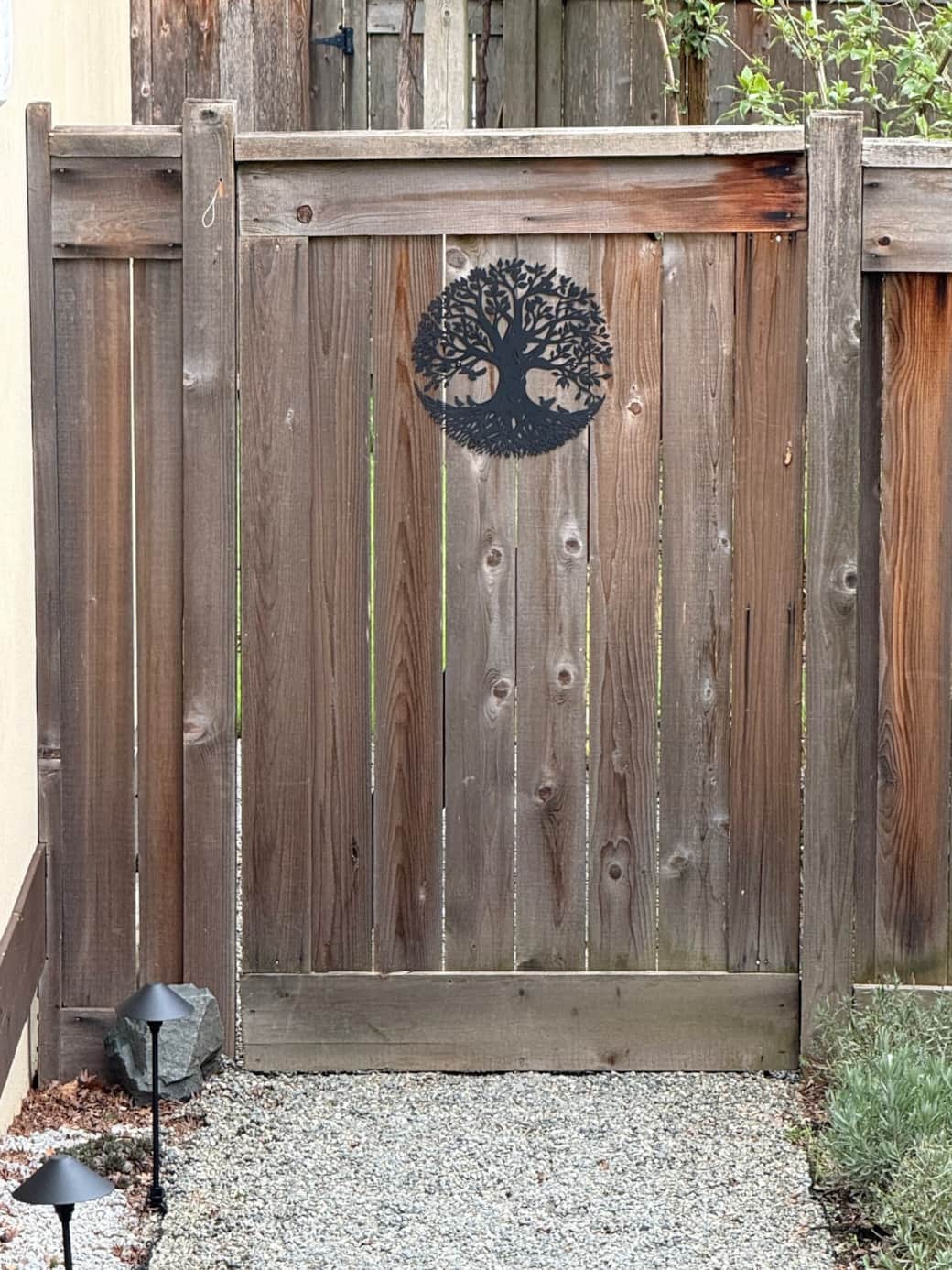 Gate with Tall Trees logo. Pull string to gain access to rear path and entry door
