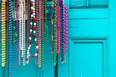 Walking around Galveston from White Magnolia guests will find many homes with beads adorning their porches and fences.