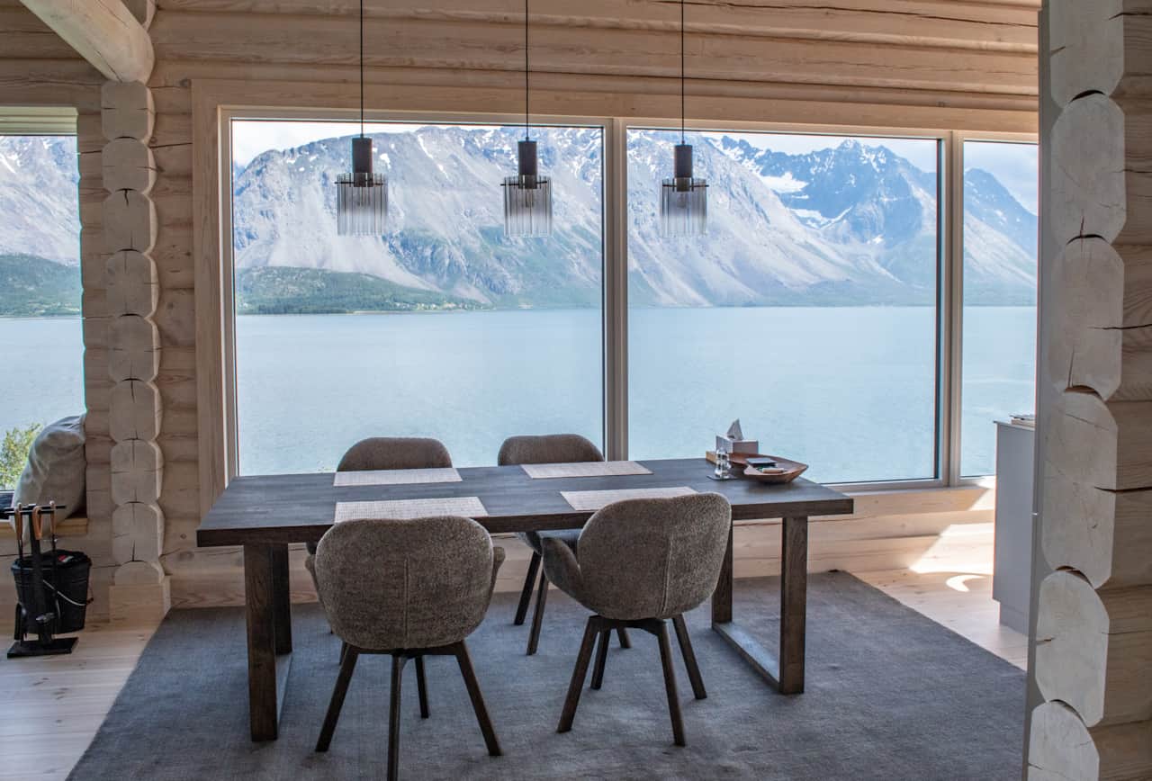 Table set the length of the window, the Lyngen Alps filling the glass.