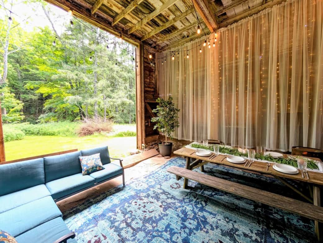 Barn sitting area and part of the dining area. (table top setting generated by AI)