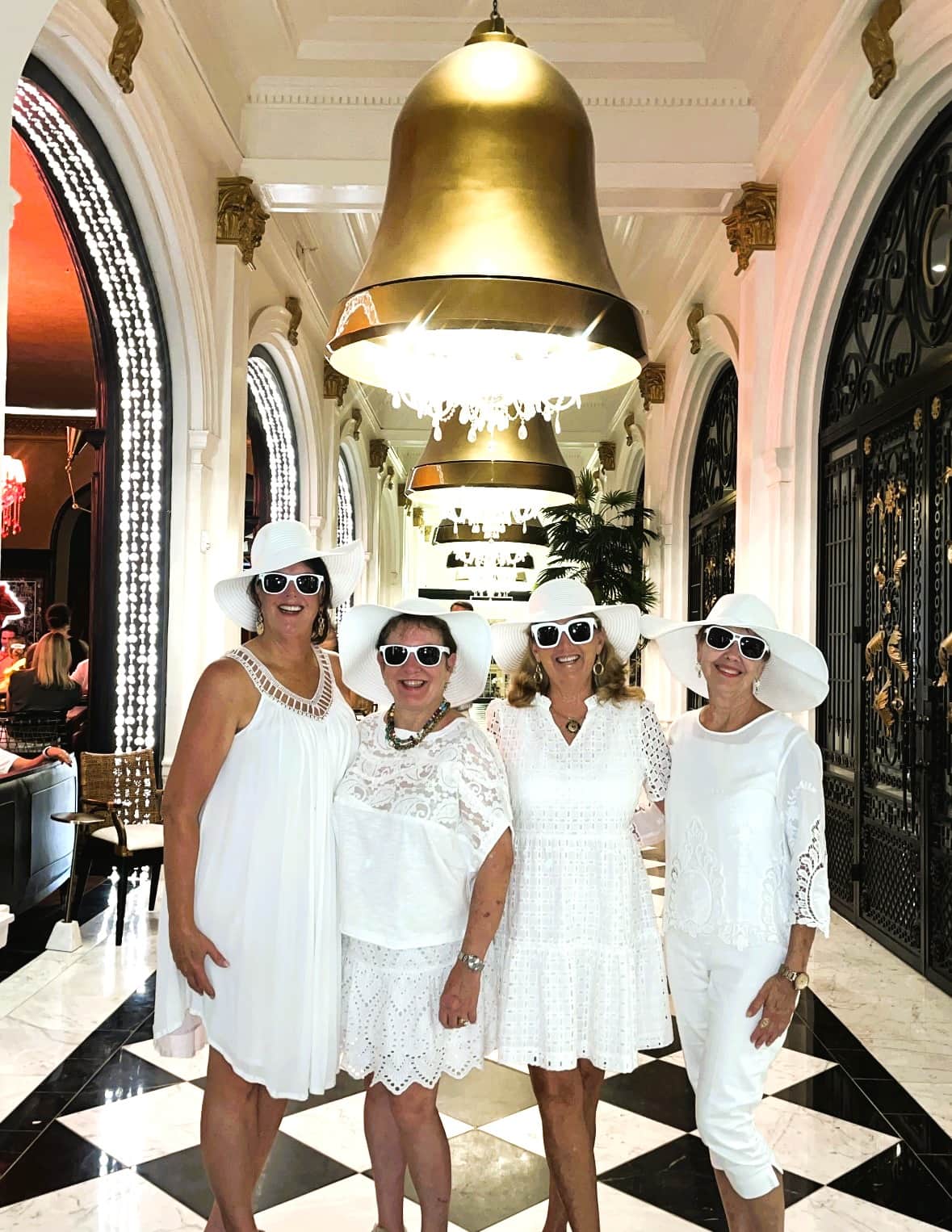 Group of women dressed in white at the Grand Galvez Hotel in Galveston for an evening out