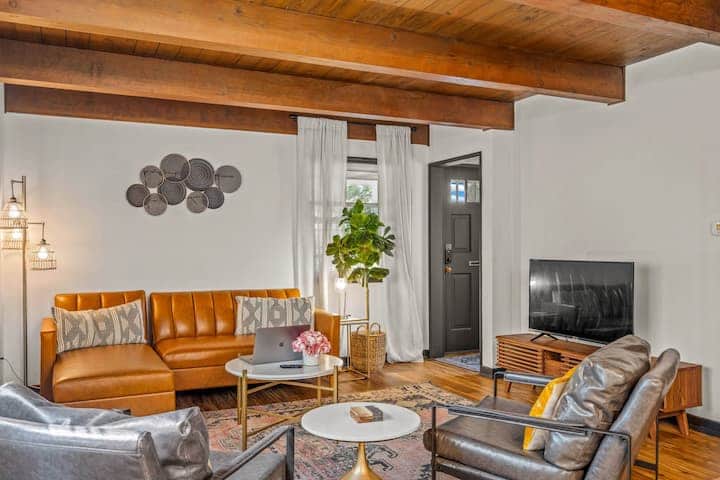 Warm and inviting living room with exposed wood beams and beautiful natural light.