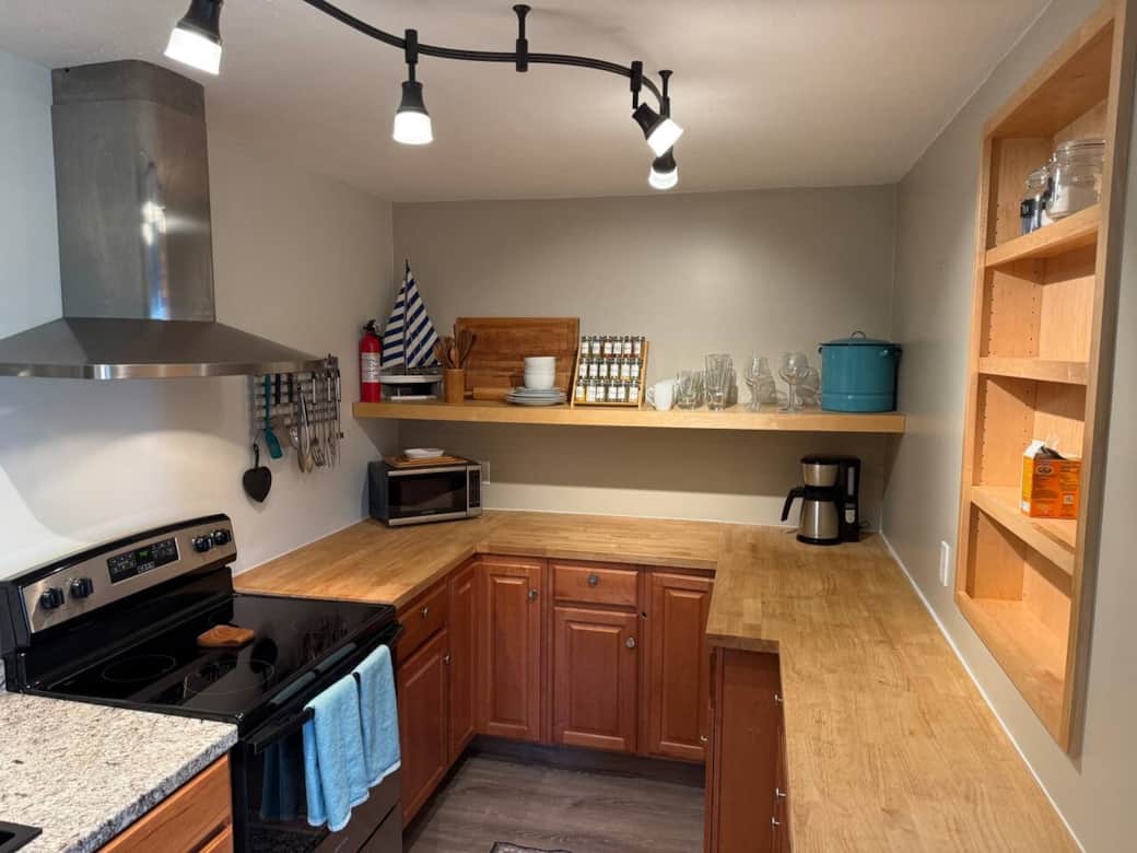 Fully equipped kitchen featuring stainless steel appliances, electric range, microwave, coffee maker, cookware, and plenty of counter space for preparing meals during your stay.
Fully equipped kitchen featuring stainless steel appliances, electric range, microwave, coffee maker, cookware, and plenty of counter space for preparing meals during your stay.