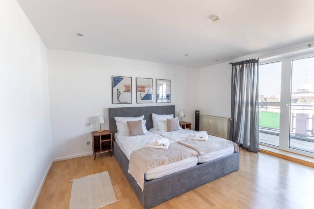 Large bedroom with king-size bed and balcony access
