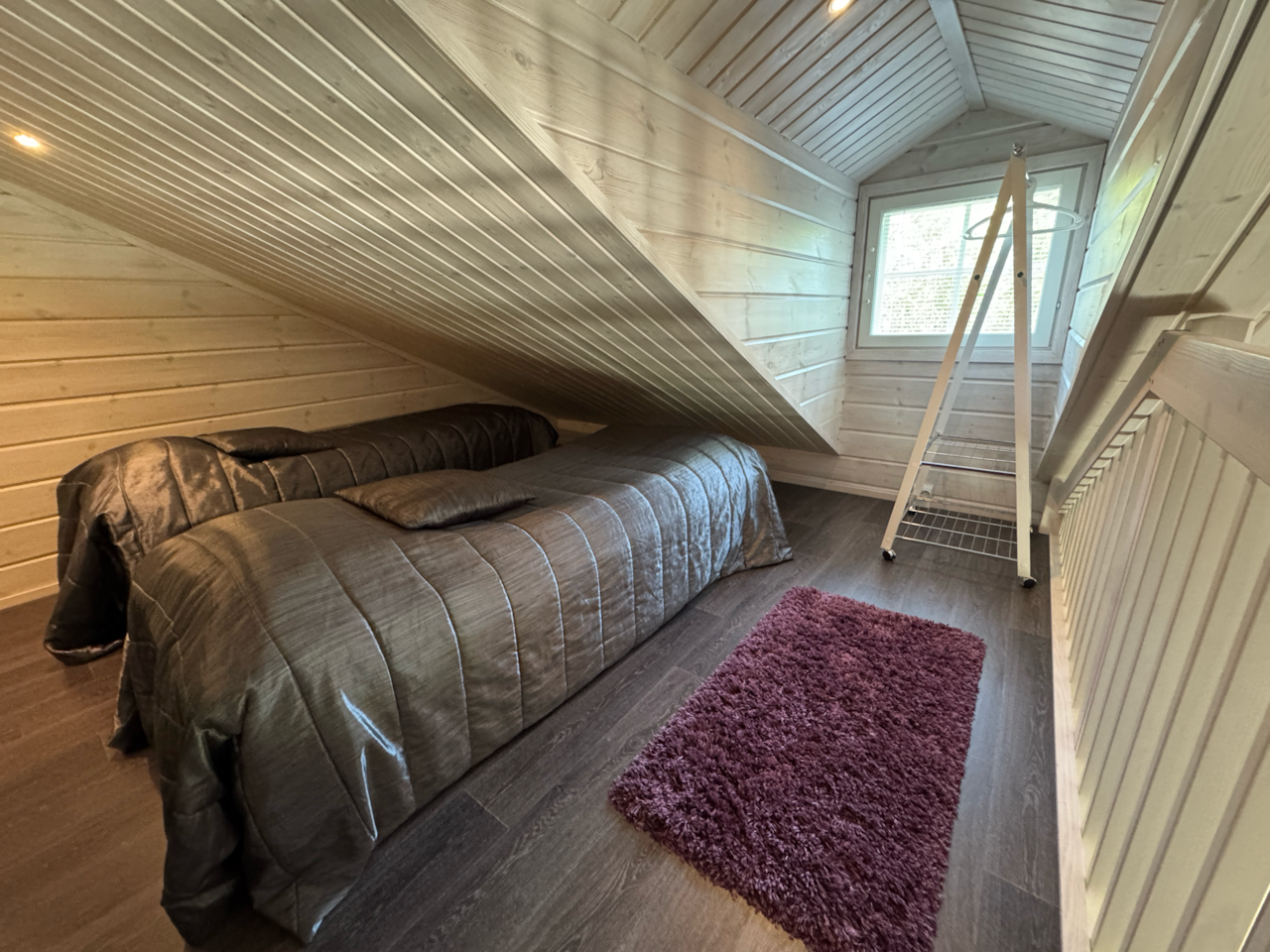 Upstairs: two separate beds and clothes hanging rail.