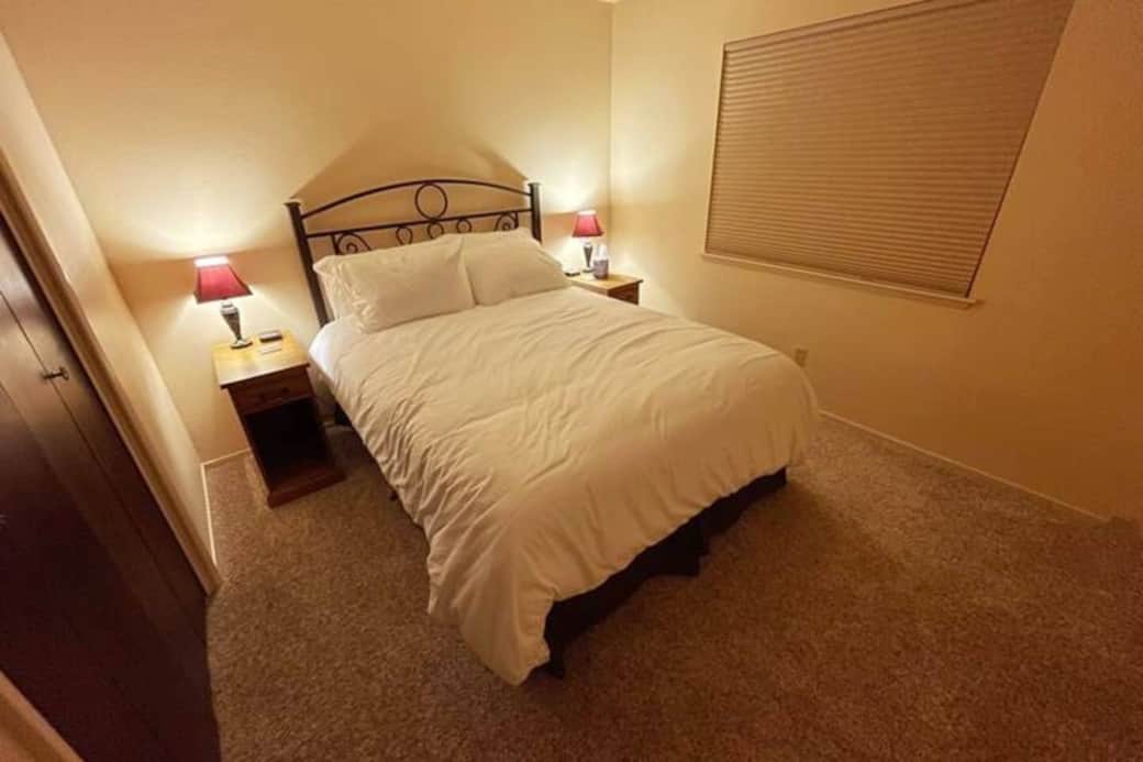 The cozy third bedroom contains a queen bed with a window looking into the fenced backyard area. All nightstands have  outlets to charge your devices nearby while you sleep.