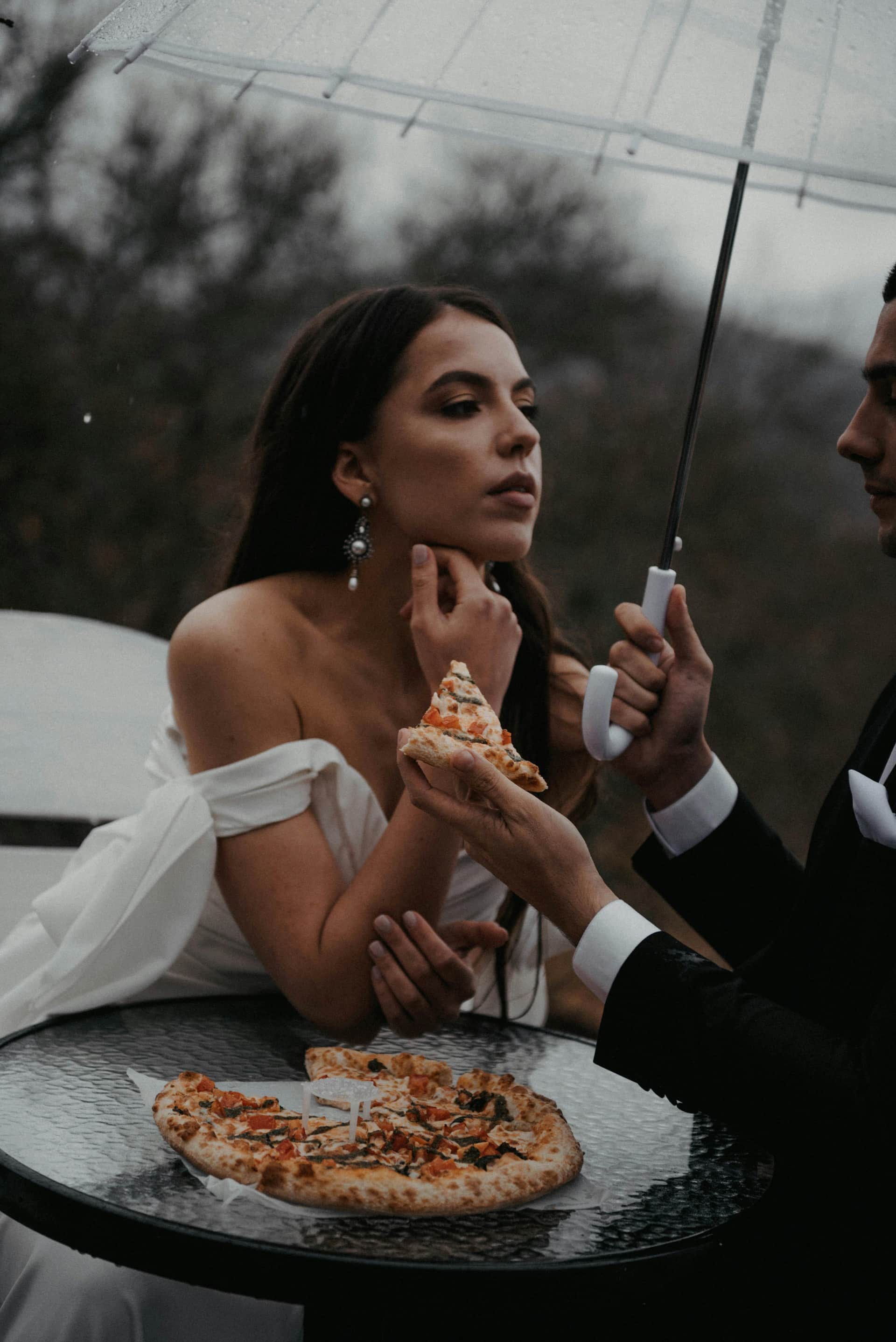Bride laughing in the rain