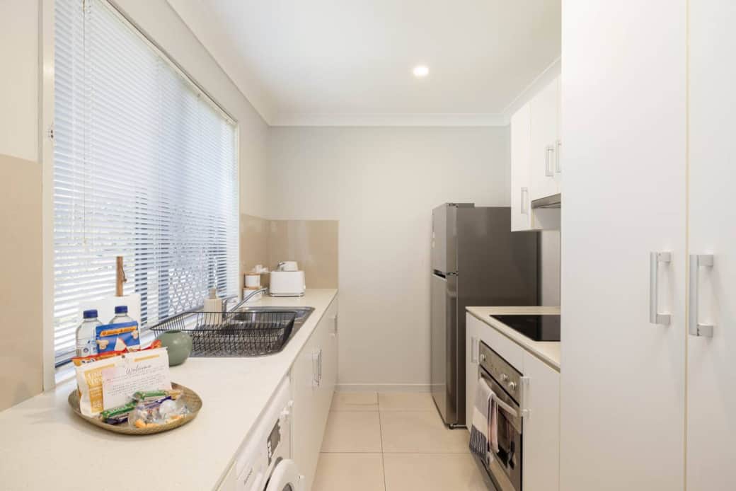 Kitchen: Sleek kitchen with ample storage, modern appliances 
