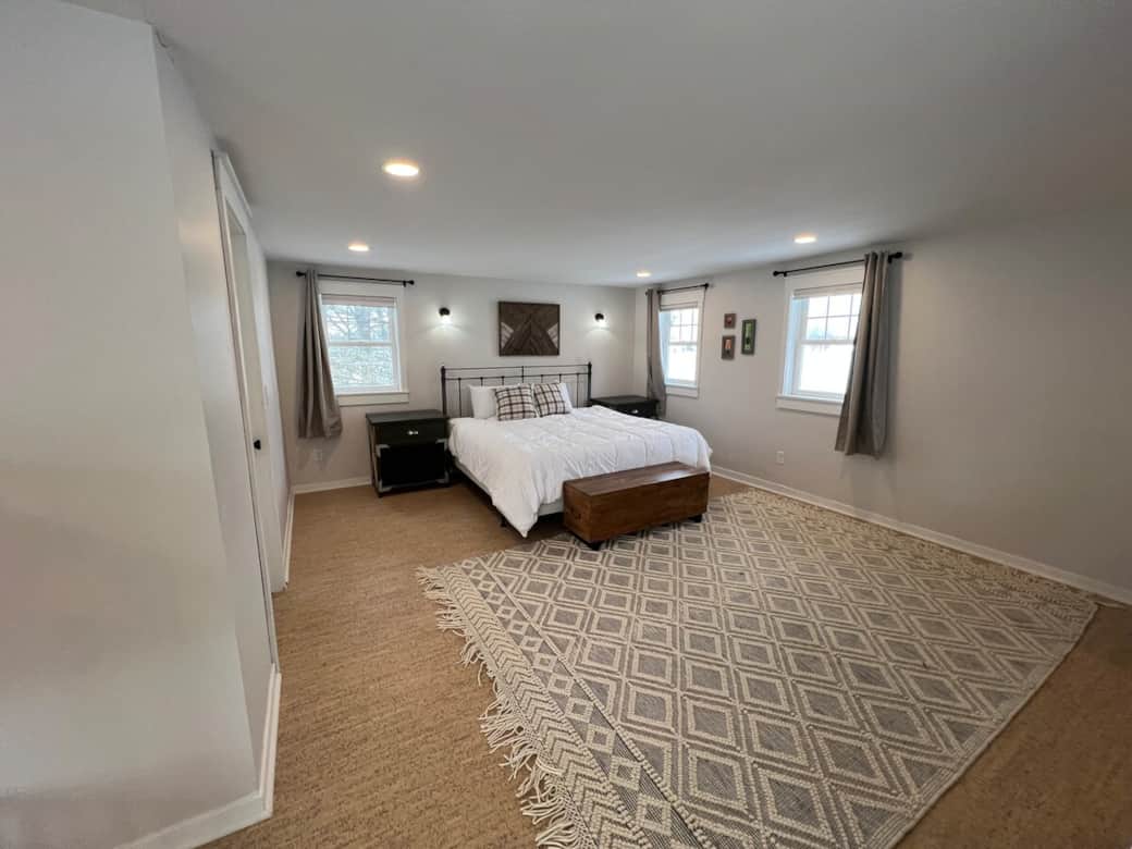 King bed in loft with blackout and light filtering curtains and 65" smart tv with disney+/hulu bundle