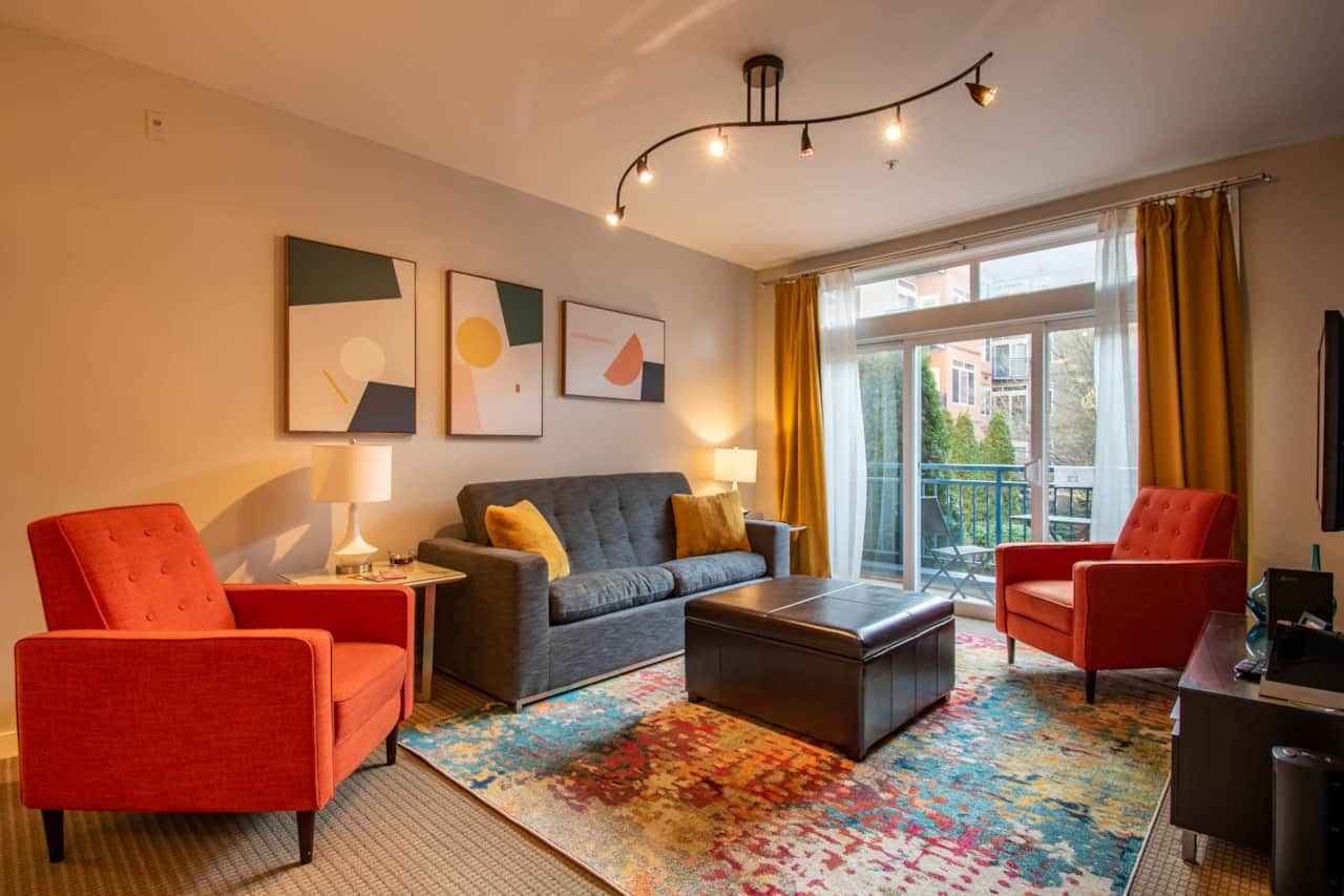 Spacious Living Room with a Private Balcony Overlooking the Serene Courtyard Garden