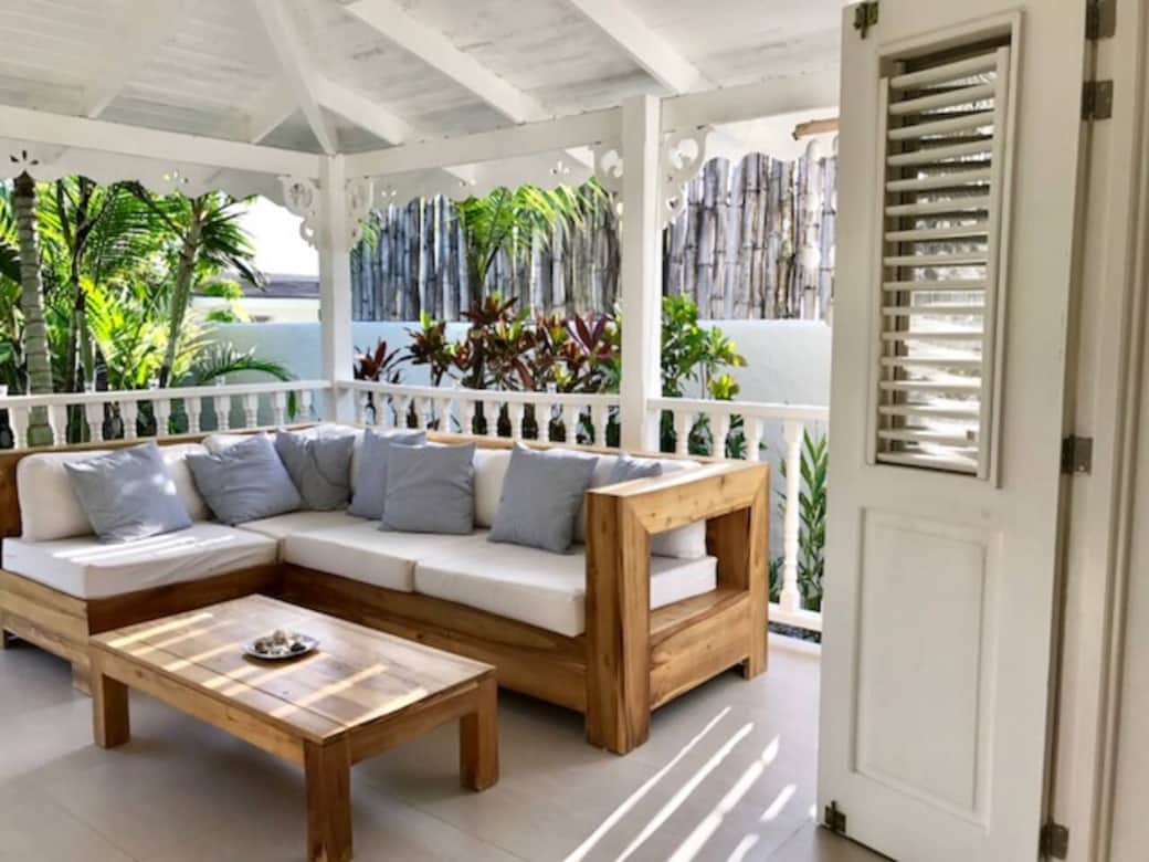 Outdoor lounge with views of the pool and garden