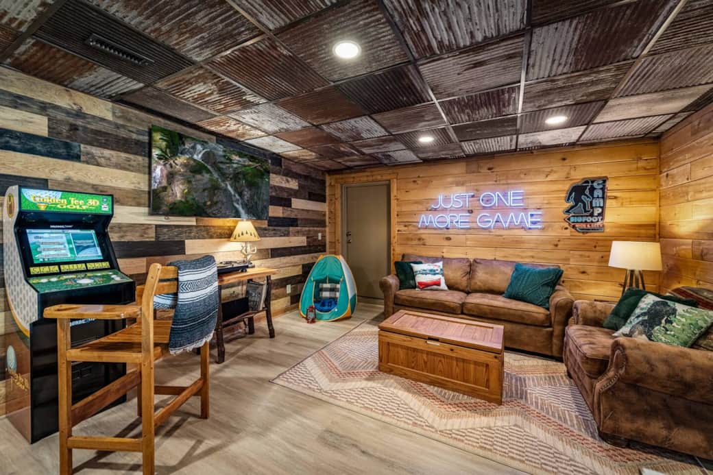 Basement arcade, vinyl record player, Sonos speaker, and queen pullout sofa bed with a memory foam mattress. 