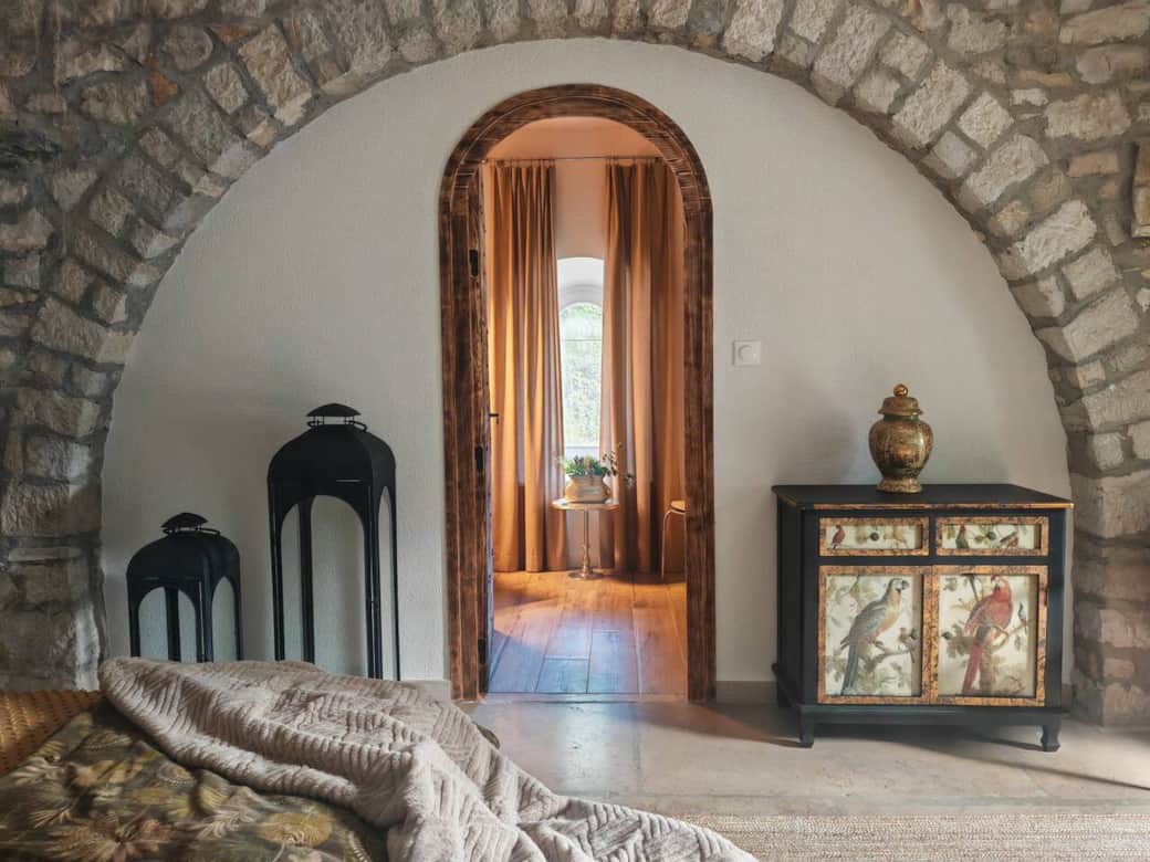 Original stone arch connecting the bedroom and bathroom