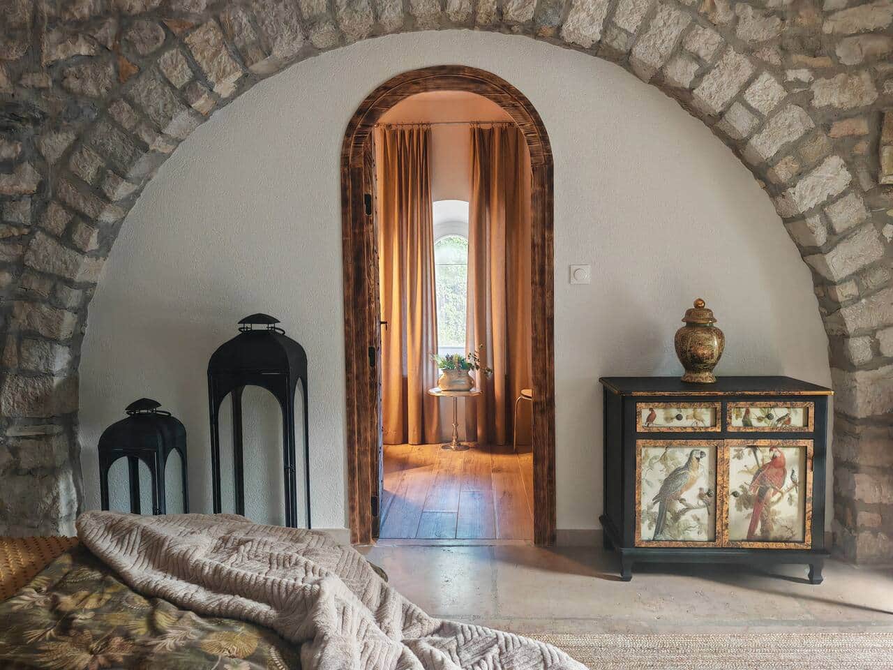 Original stone arch connecting the bedroom and bathroom