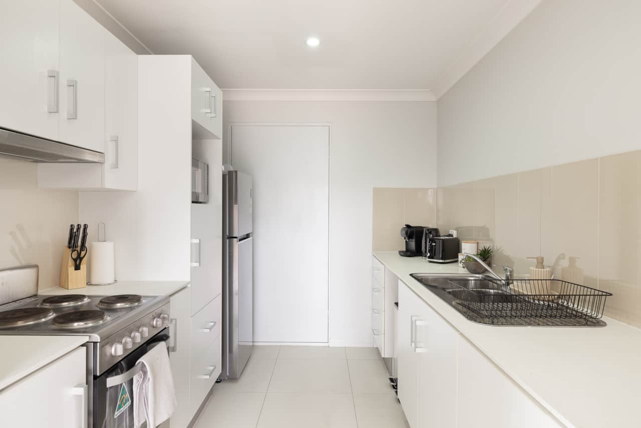 Kitchen: Sleek kitchen with ample storage, modern appliances 