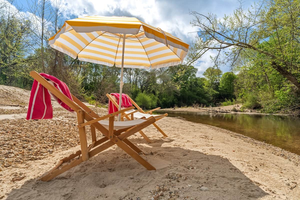 Spend the day on your own private sandbar—lounging under the umbrella, feet in the cool, clear water, with nothing but the sound of the creek moving past. 