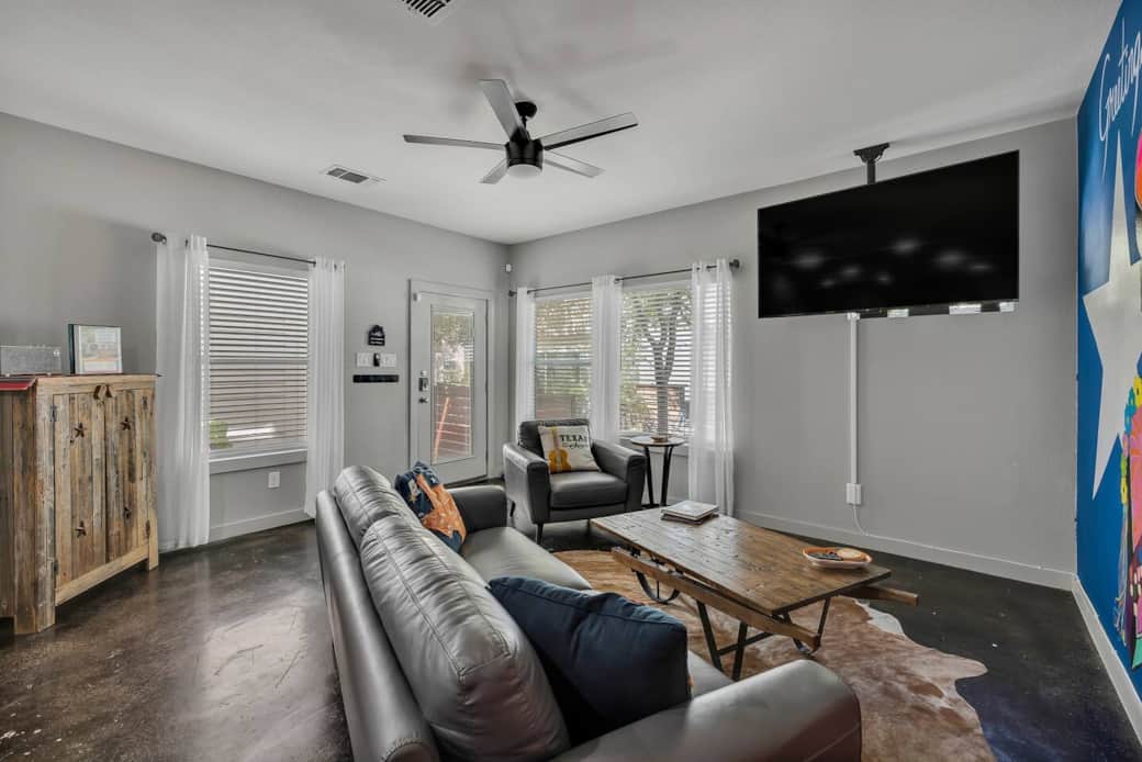 The open living room boasts a 65" smart Roku TV that allows you to use your Netflix, HULU, or other accounts. It also allows for SmartCasting from your iPhone as well as a new leather couch and chair.