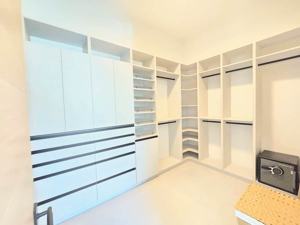 Primary Suite custom walk-in closet with built-in drawers in the primary suite at Casa Tropicana SK