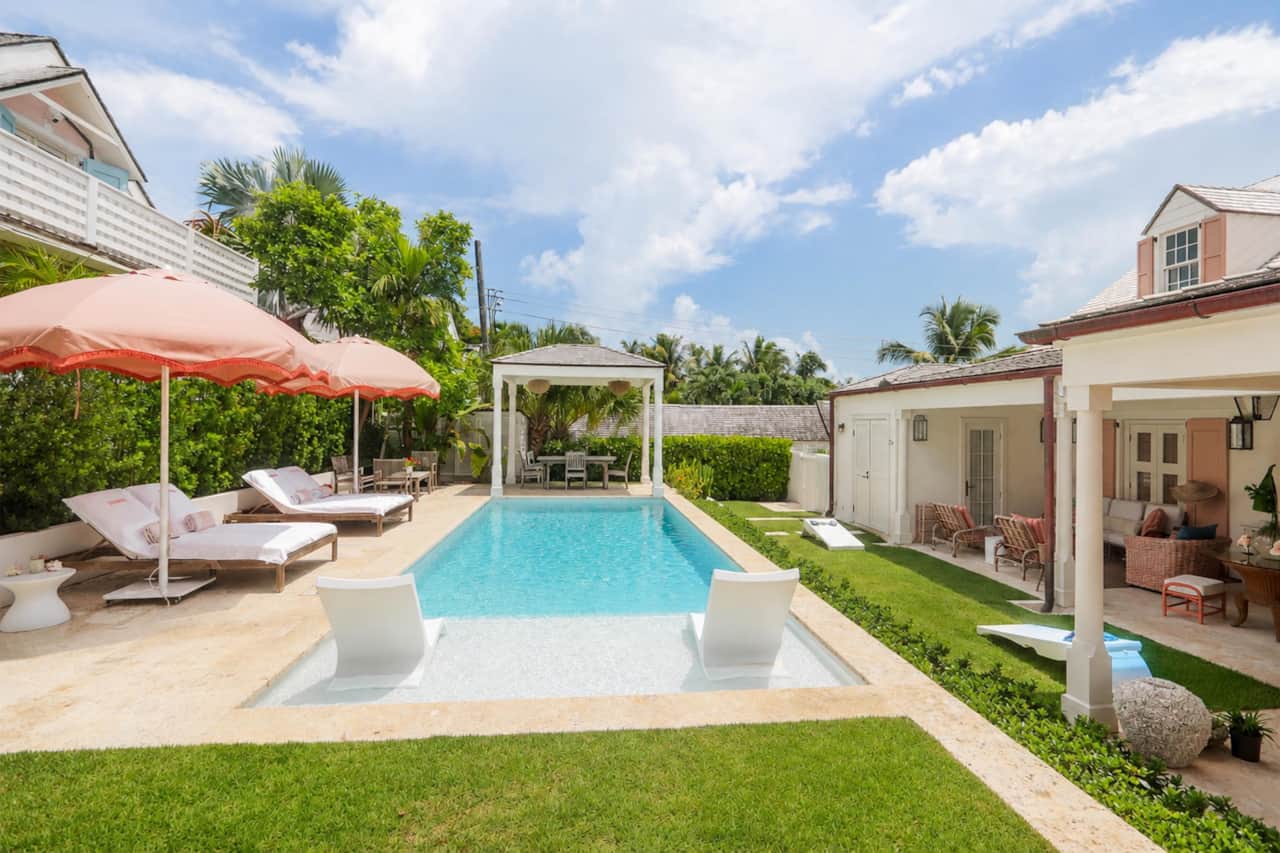 Harbour Island Dunmore Cottage pool flanked by Main House terrace and shaded loungers
