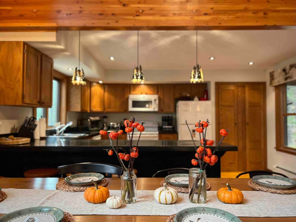 The fully stocked kitchen invites you to gather with loved ones, stirring, savoring, and sharing homemade meals surrounded by laughter and the comfort of the cabin. (Decor is seasonal)