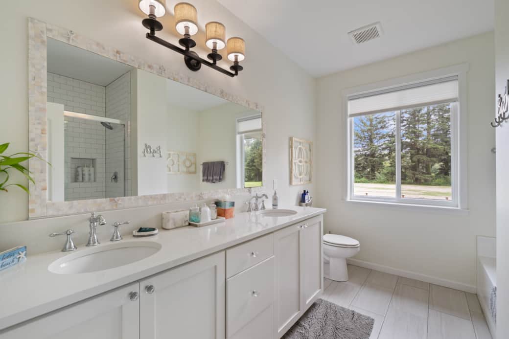 Elegant master bath with a separate tub, large shower, and dual sinks for comfort and style.