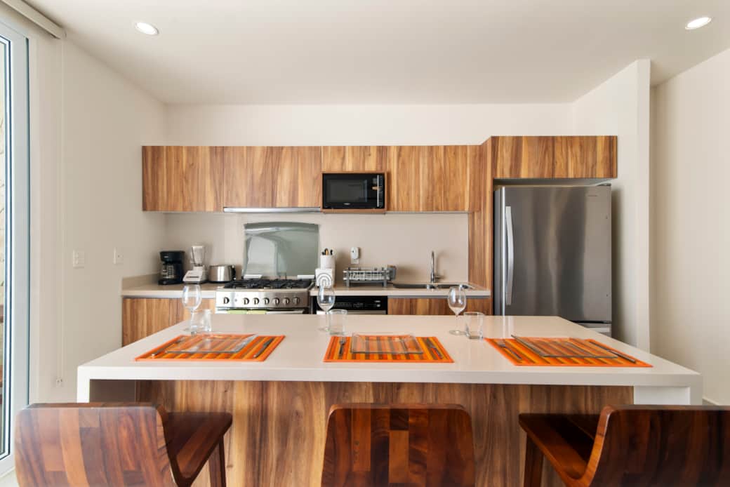 Dining for three at the kitchen island with comfy stools nearby.