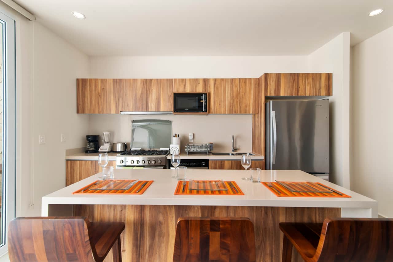 Dining for three at the kitchen island with comfy stools nearby.