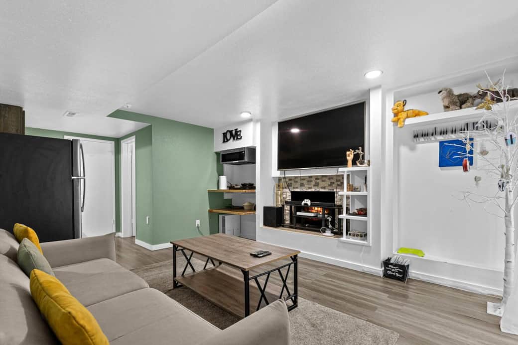 Kick back and relax in the cozy living area featuring a plush sofa, large TV, and open layout. Here we provide X-box, and Apple TV, Netflix, YouTube, and Amazon Prime Video for your entertainment.