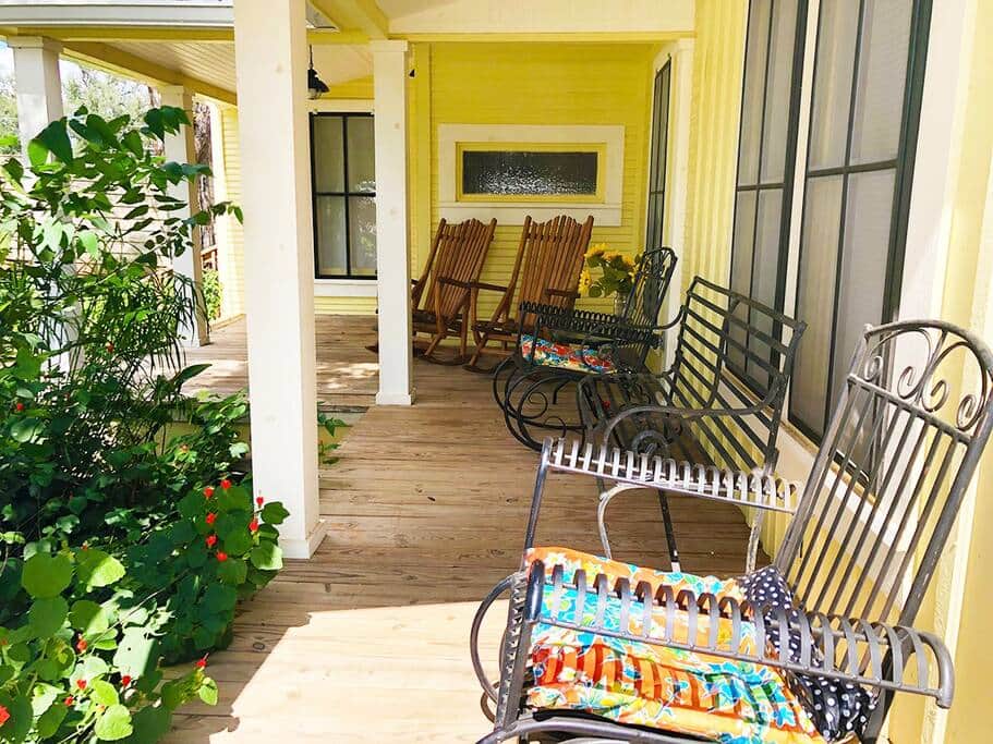 Covered Porch With Lots of Chairs For Relaxing & Listening to the Soothing Pond