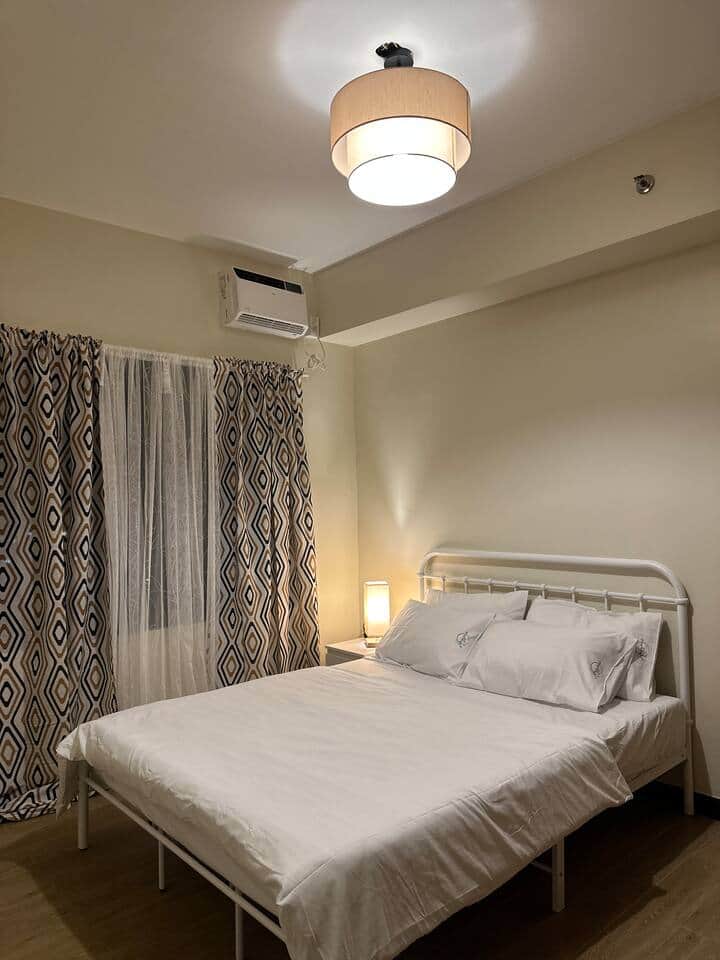 Bedroom 1 offers a cozy queen-size bed with a soft, comfy mattress for restful nights. An open-concept wardrobe keeps your essentials within easy reach, making you feel right at home