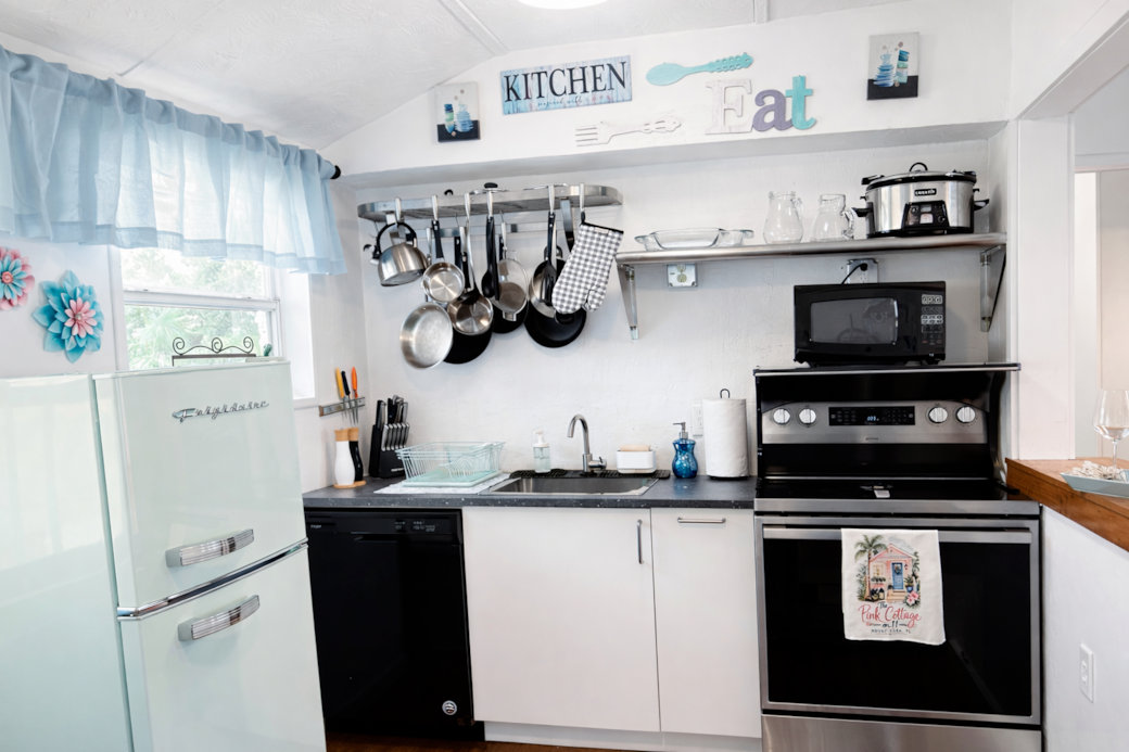 Fully equipped kitchen with modern appliances. and coffee station, 