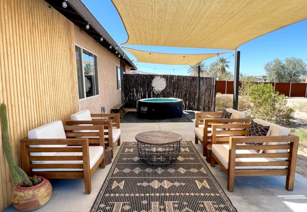 Gather under the desert sun — shaded patio with comfy lounge seating & hot tub nearby. Perfect for connection and relaxation with your friends and family.