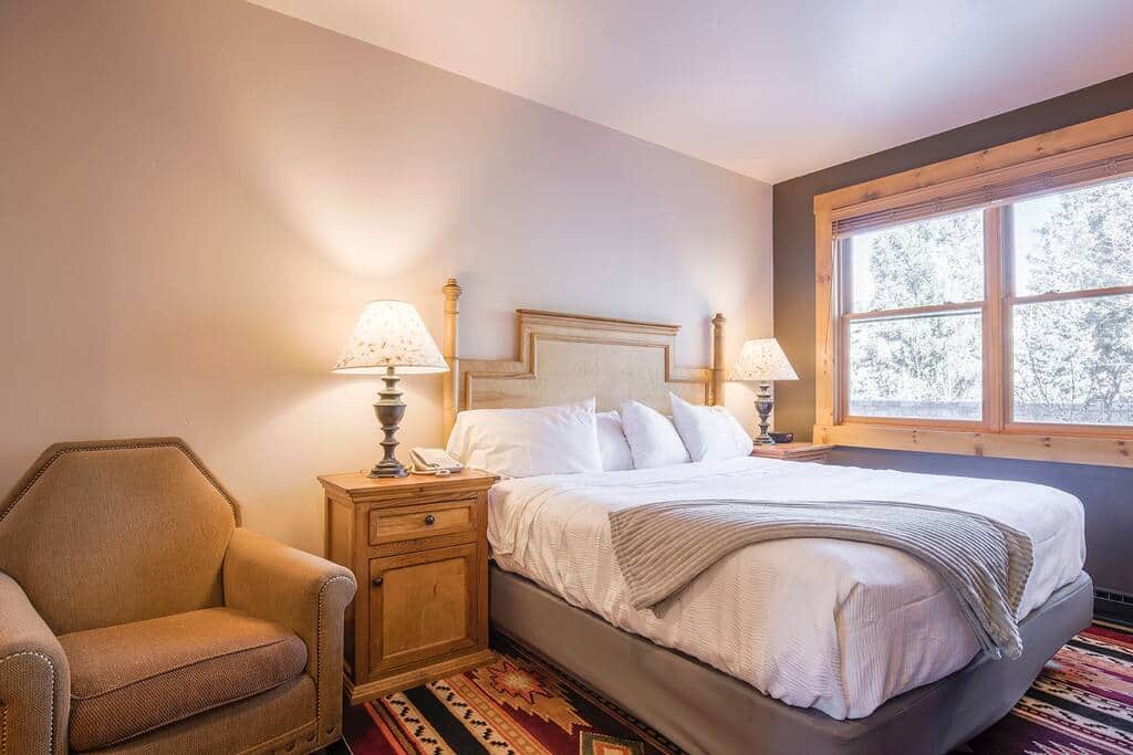 King bed in bedroom area with open green space and mountain views! 