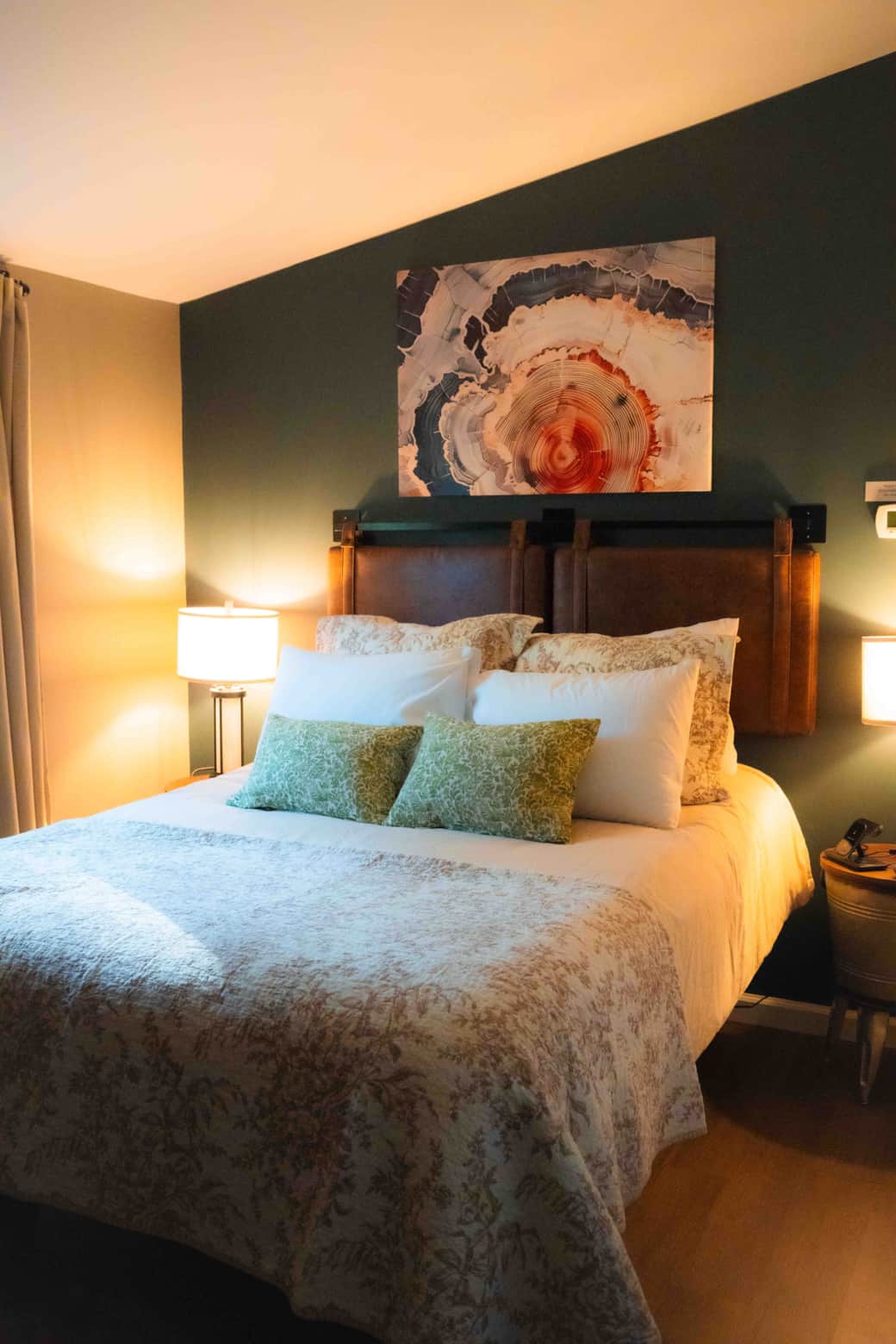 Queen adjustable bed with luxurious bedding & wall mounted tv and phone chargers.