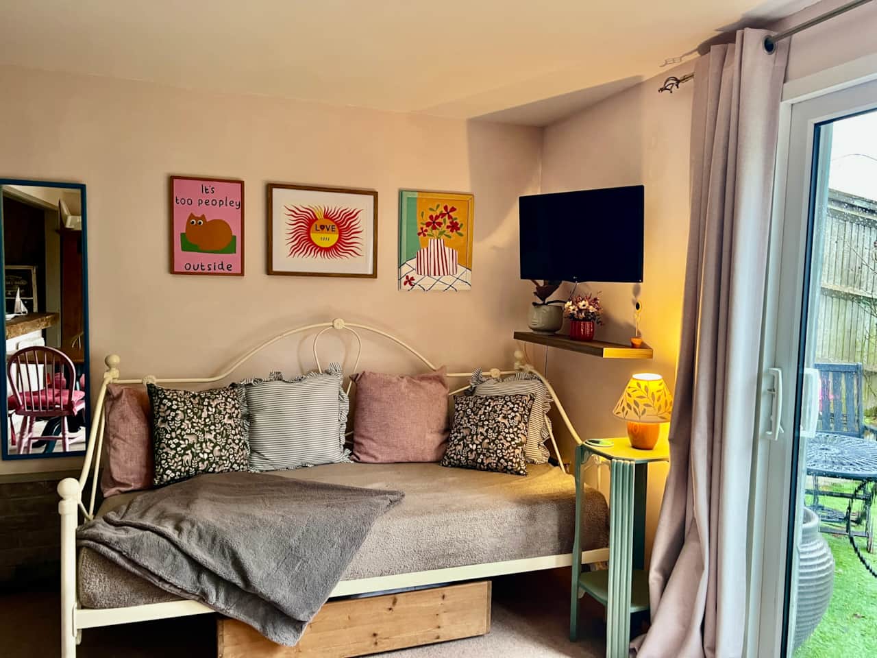 One side of the lounge area which features a tv and day bed which is converted into a bed on request