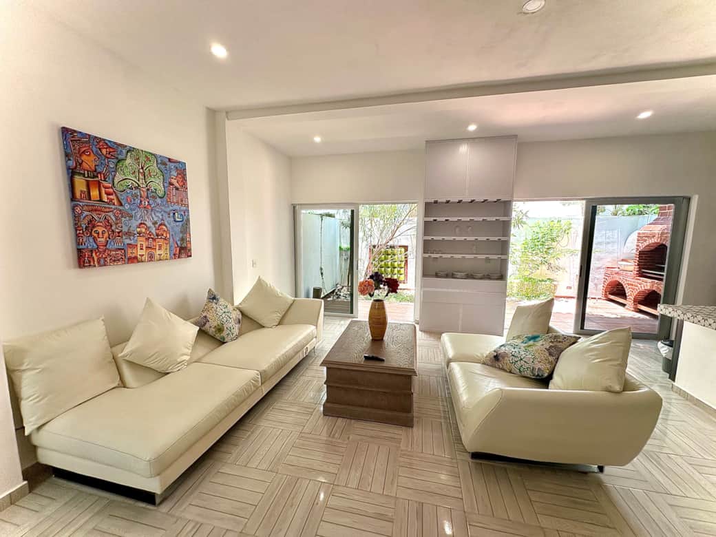 Open living space: living room, kitchen, dining area, patio with grill