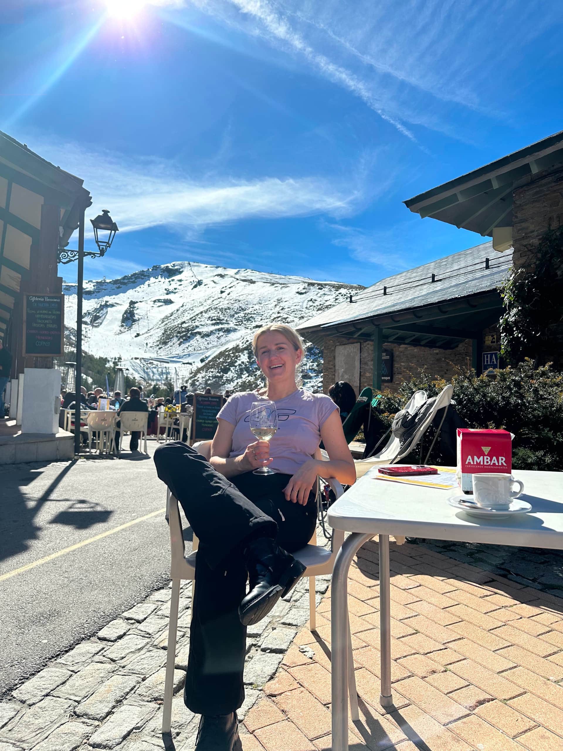 Spring skiing break in Sierra Nevada, enjoying sunshine on a mountain terrace during late-season ski day in southern Spain