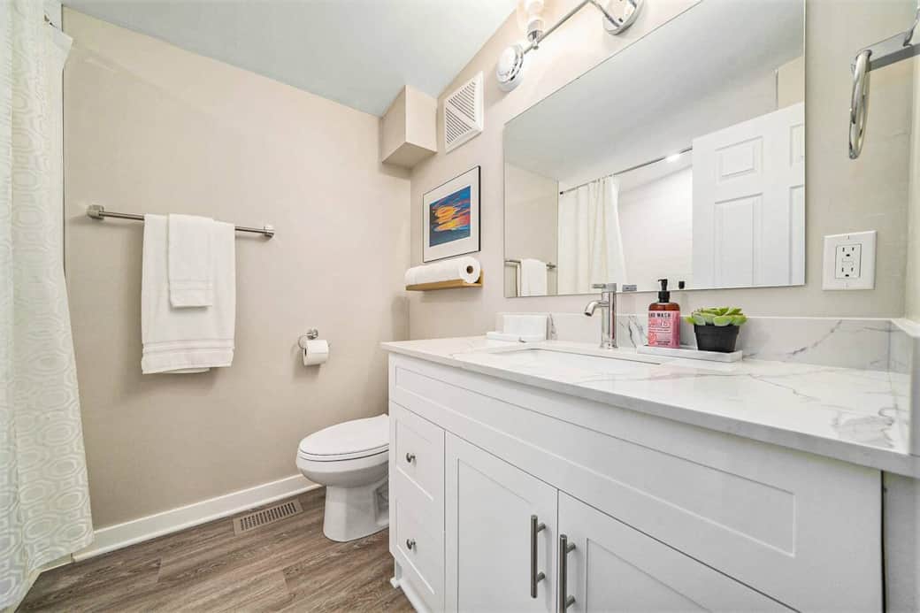 The main bathroom features a shower/tub combo, a 43” vanity & chrome finishes The main bathroom features a shower/tub combo, a 43” vanity & chrome finishes