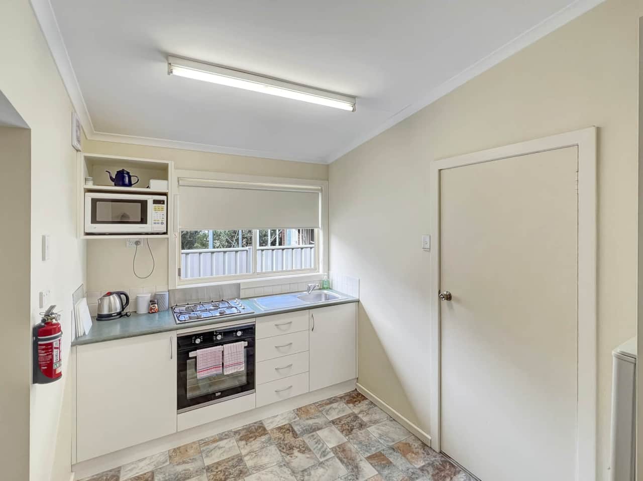 Convenient, well-equipped kitchen with gas cooktop, oven, and microwave for a delightful stay.