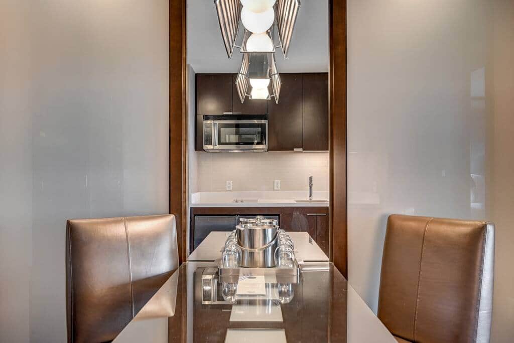 Dining Nook with Pendant Lighting and Mirror Wall Dining Nook with Pendant Lighting and Mirror Wall