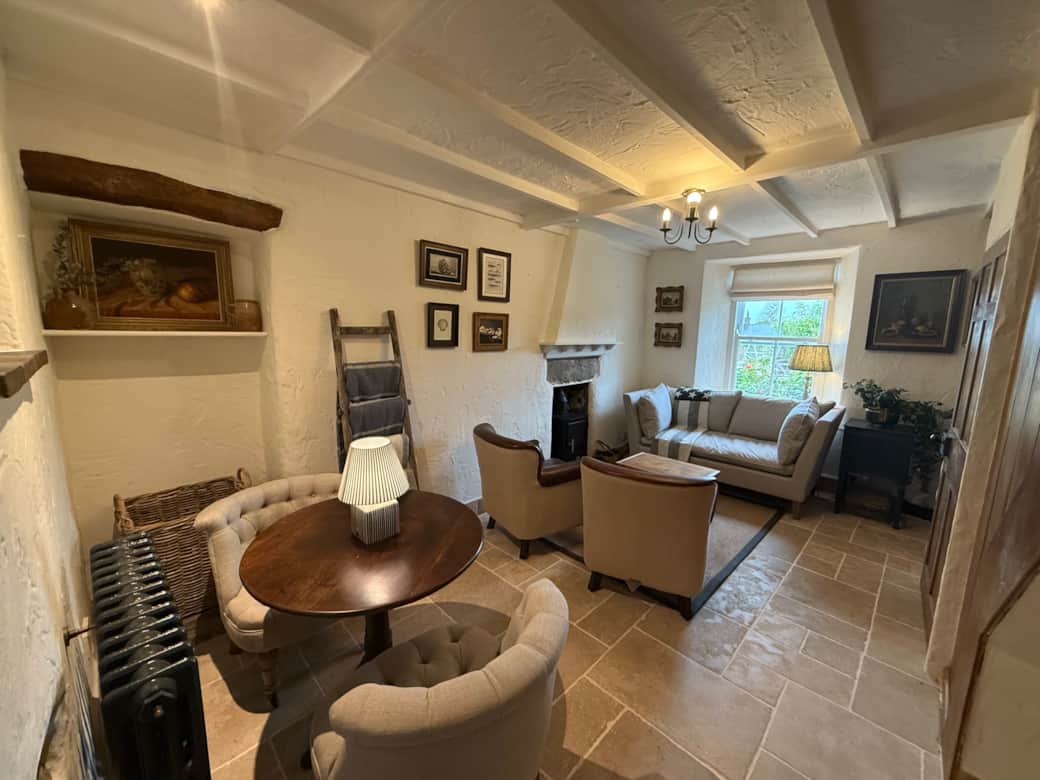 Cosy living room with log burner and comfortable sofas at Arwel Cottage, Llanbedrog