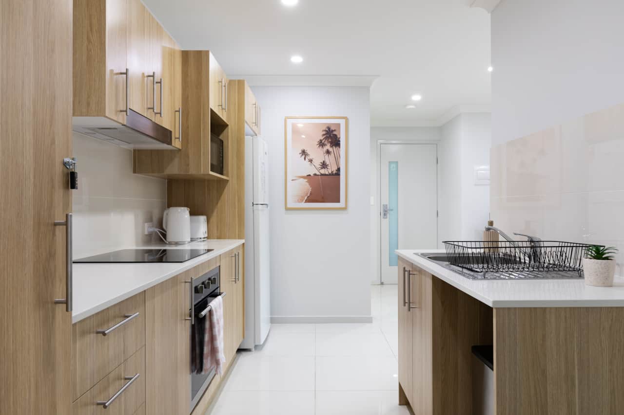 Kitchen: Sleek kitchen with ample storage, modern appliances 