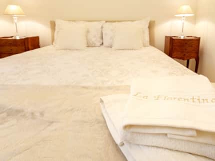 Bedroom with embroidered La Florentina linen, Apartment Three