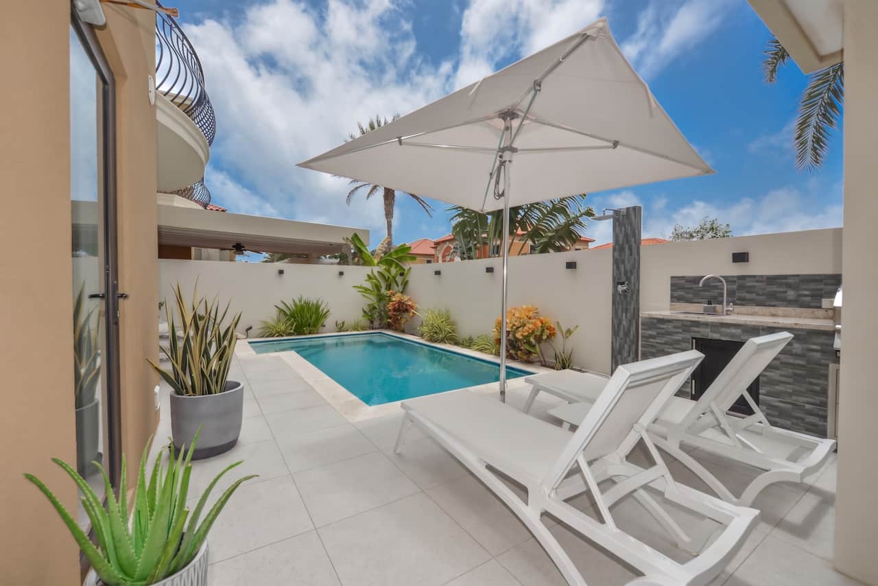 Backyard with pool-side sun loungers
