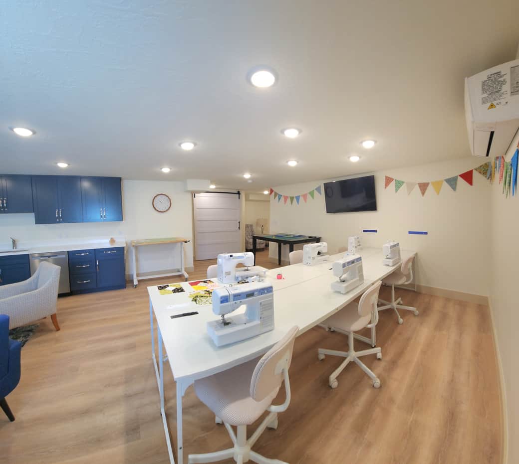 Sewing studio for six has two cutting tables, two ironing stations, and comfortable sewing chairs. Sewing studio for six has two cutting tables, two ironing stations, and comfortable sewing chairs.